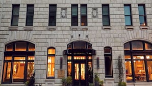 A historic building with a symmetrical facade, large arched windows, and a central entrance with a sign reading "The Drayton Hotel." - The Drayton Hotel Savannah, Curio Collection by Hilton (Savannah)