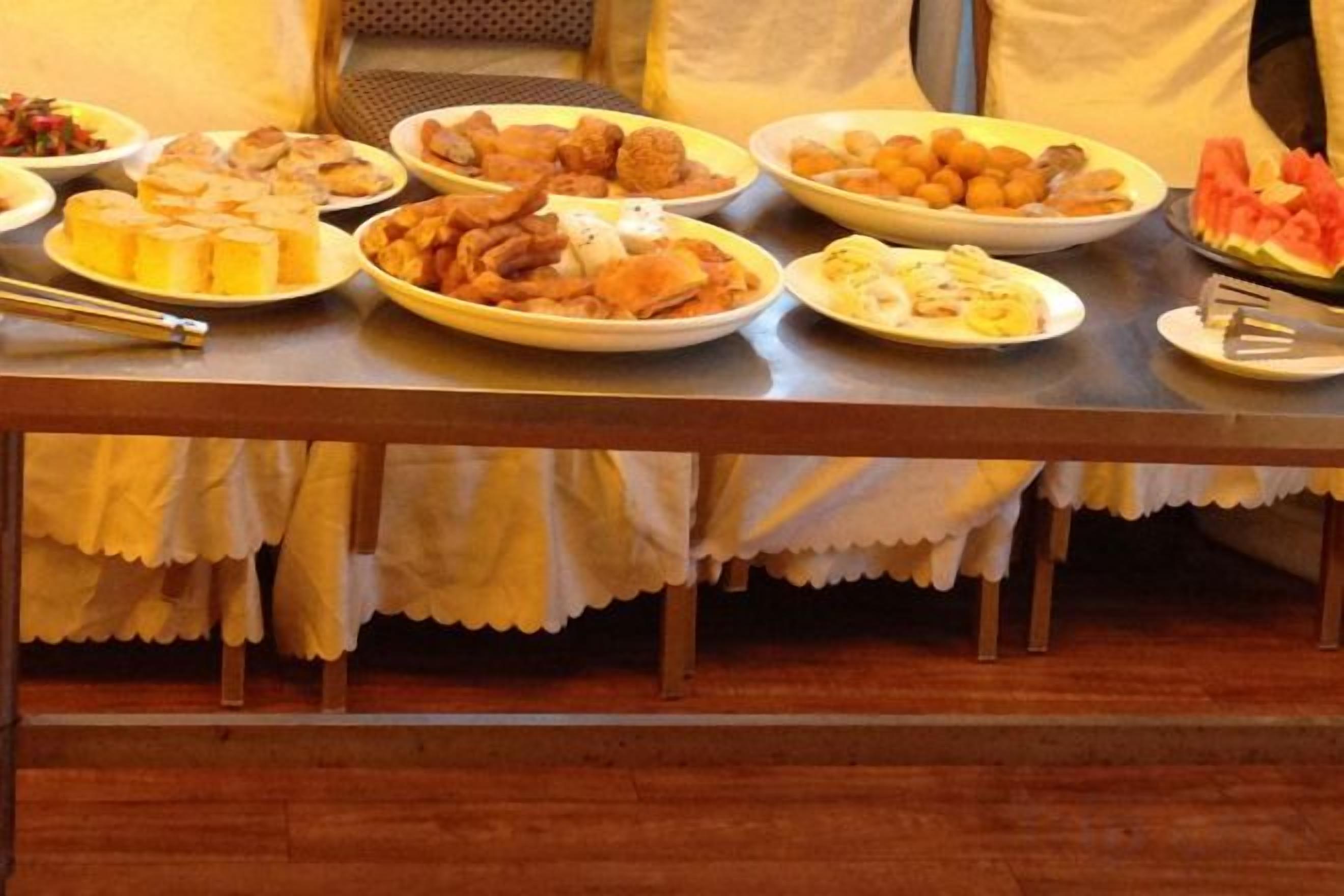 A table with various food items, likely for a buffet or communal meal.