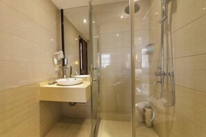 A modern bathroom with a glass-enclosed shower, a sink with a mirror, and a toilet. - Binfen Grand Hotel (Wuhu)