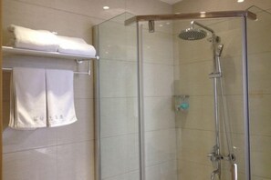 A glass-enclosed shower with a handheld showerhead, a towel rack with a folded towel, and a wall-mounted towel rack with a folded towel. - Binfen Grand Hotel (Wuhu)