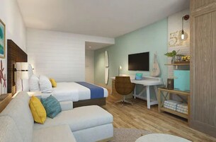 Una habitación de hotel moderna con cama, sofá, escritorio y televisor.