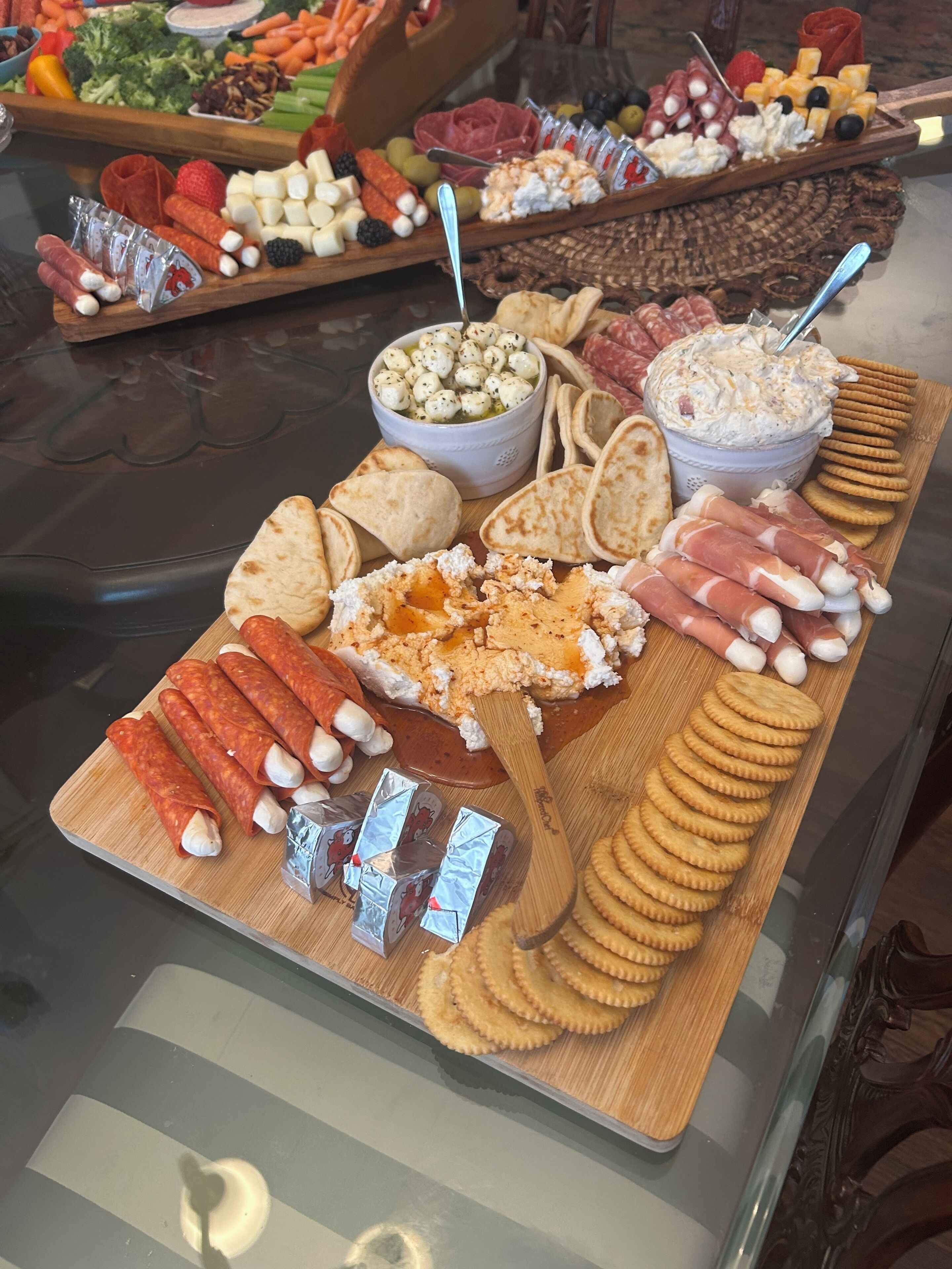 A charcuterie board with various meats, cheeses, and crackers.