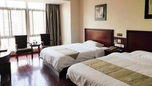 A hotel room with two beds, a desk, a chair, and a window with curtains. - Greentree Inn Yingtan Bus Station Express Hotel (Yingtan)