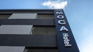 A hotel sign with the name "MOC Hotel" against a clear sky. - Moca Hotel (Bangkok)
