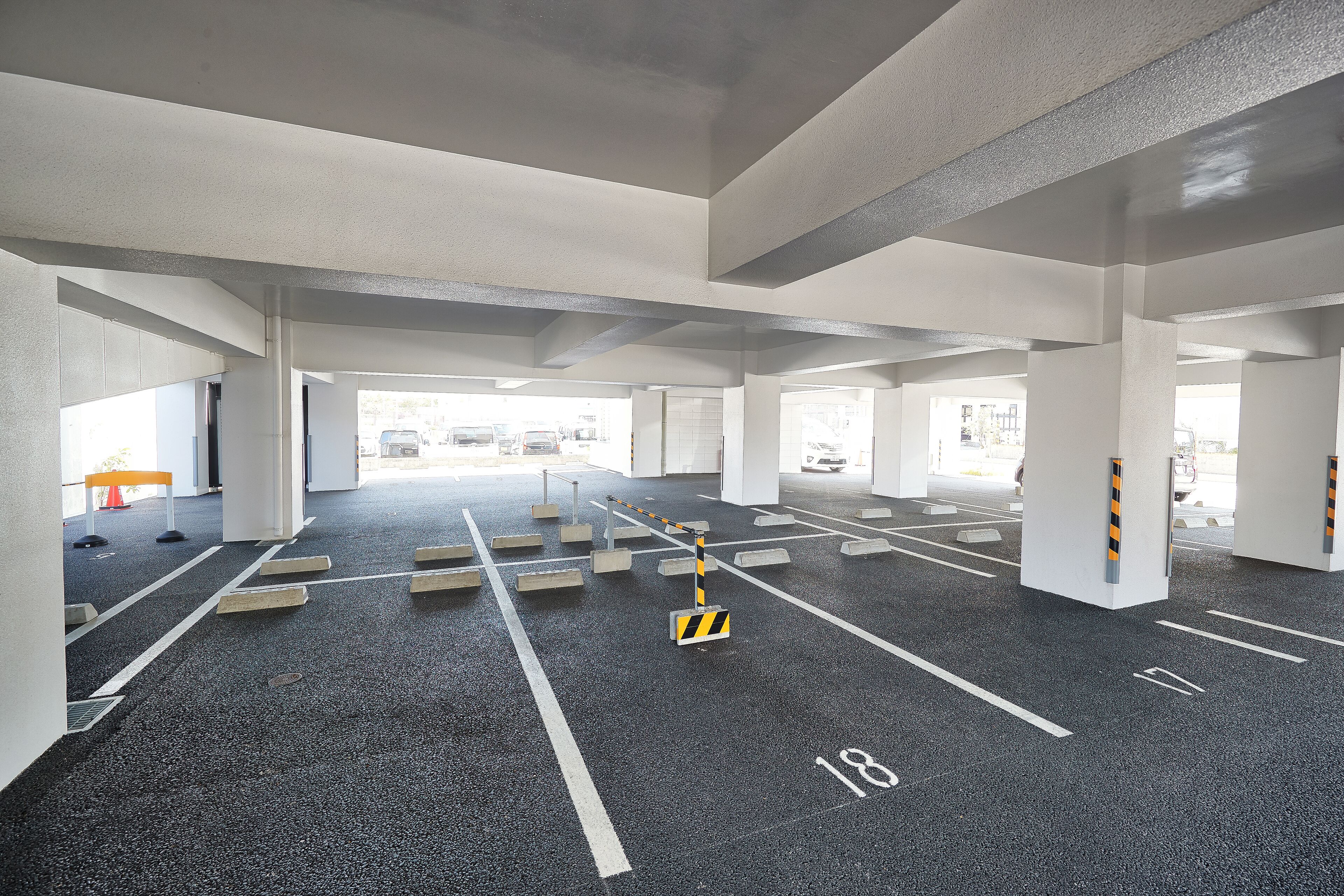 A parking garage with clear lane markings and bollards.