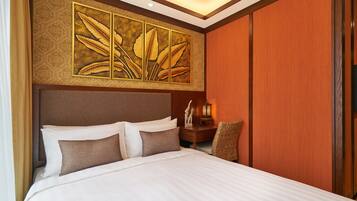 A hotel room with a large bed, a headboard, a wall-mounted artwork, a nightstand, and a chair.