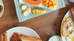 A breakfast plate with eggs, sausages, beans, toast, and mushrooms. - Hotel Boutique Lacoul Inn (Siddharthanagar)