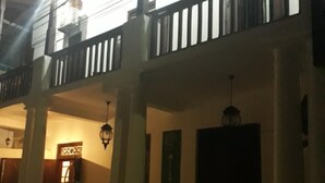 A two-story building with a balcony, columns, and a door. - Lighthouse Guest (Galle)