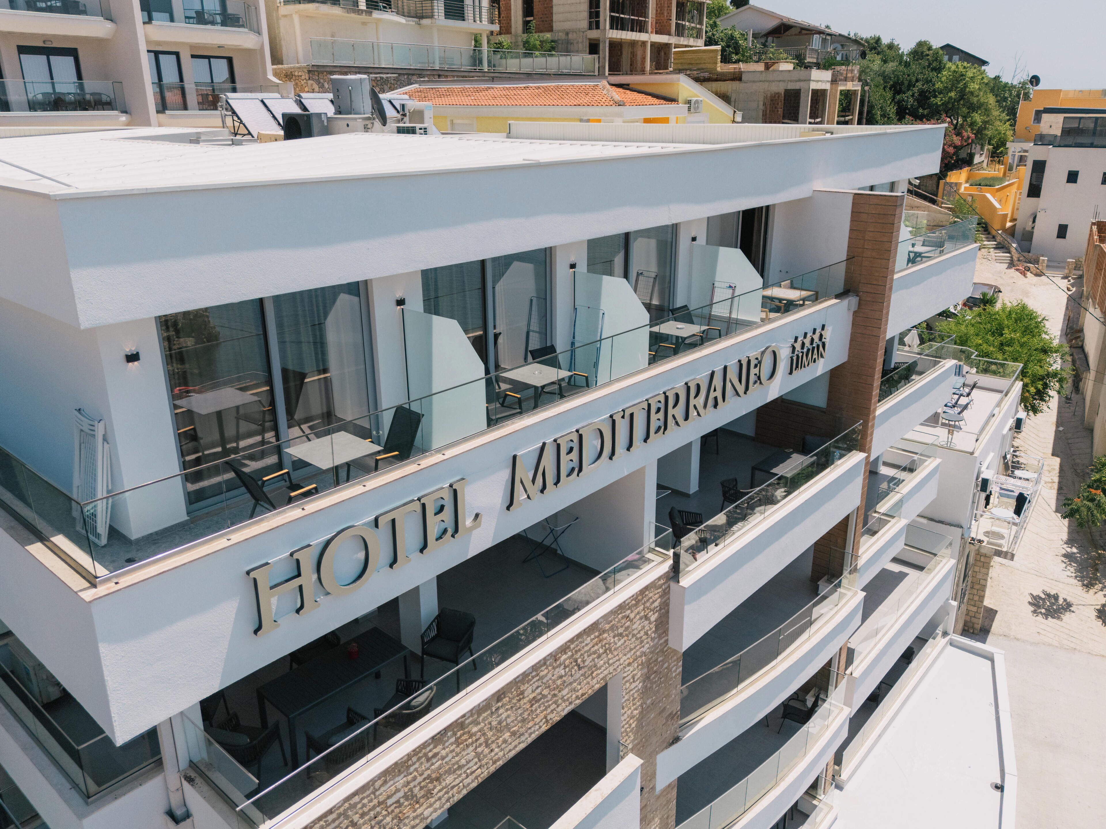 Un hotel de diseño moderno, con varios balcones y una vista despejada del entorno.