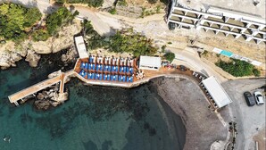 An aerial view of a coastal hotel with a pier, a pool area, and a beach. - HOTEL MEDITERRANEO LIMAN free private beach for hotel guest (Ulcinj)
