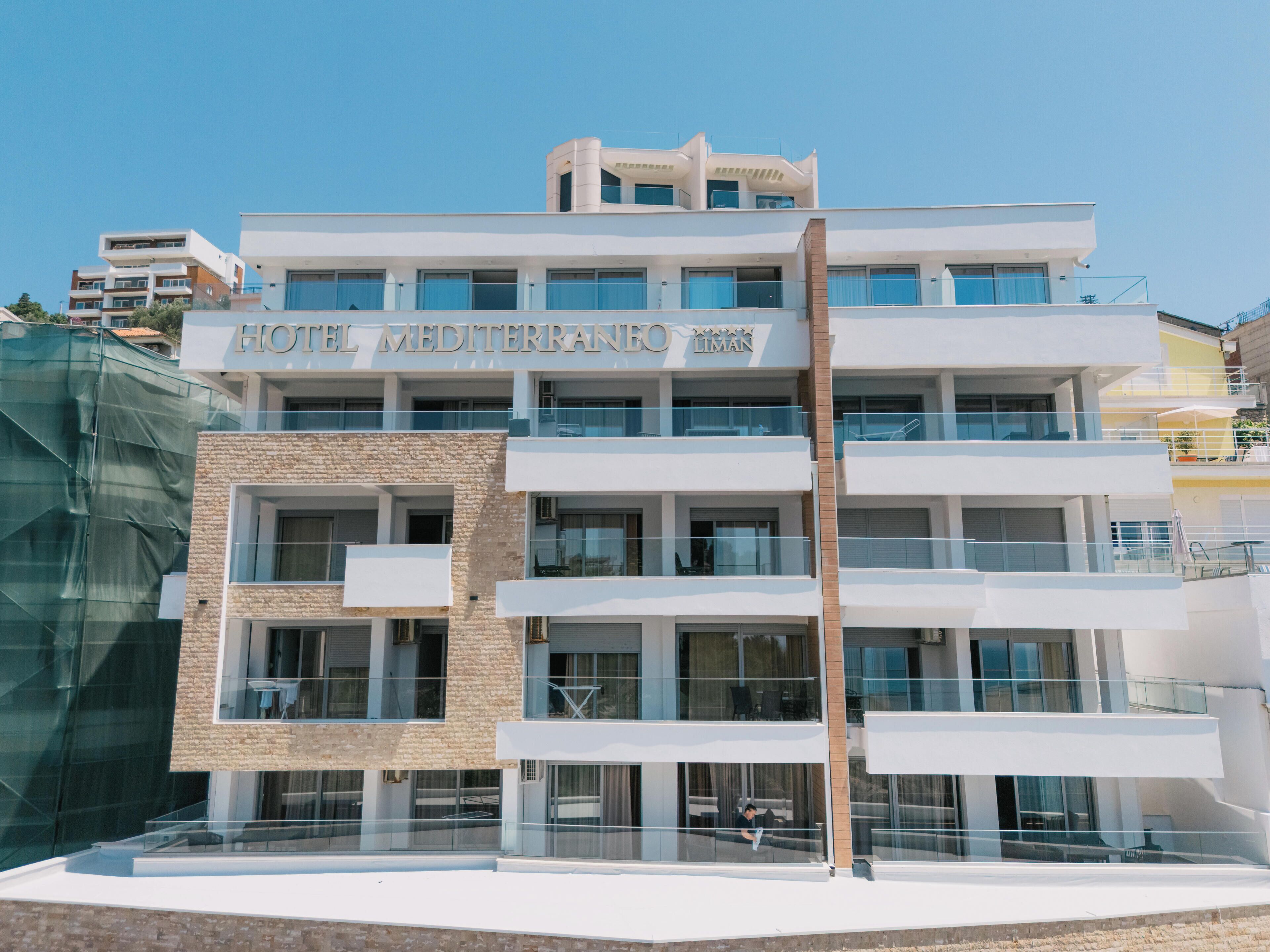 A multi-story hotel with a clear sign reading 'HOTEL MEDITERRANEO LIMAN'.