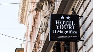 A sign for Hotel Youri Il Magnifico with contact information and a website URL. - Hotel Youri Il Magnifico (Genoa)