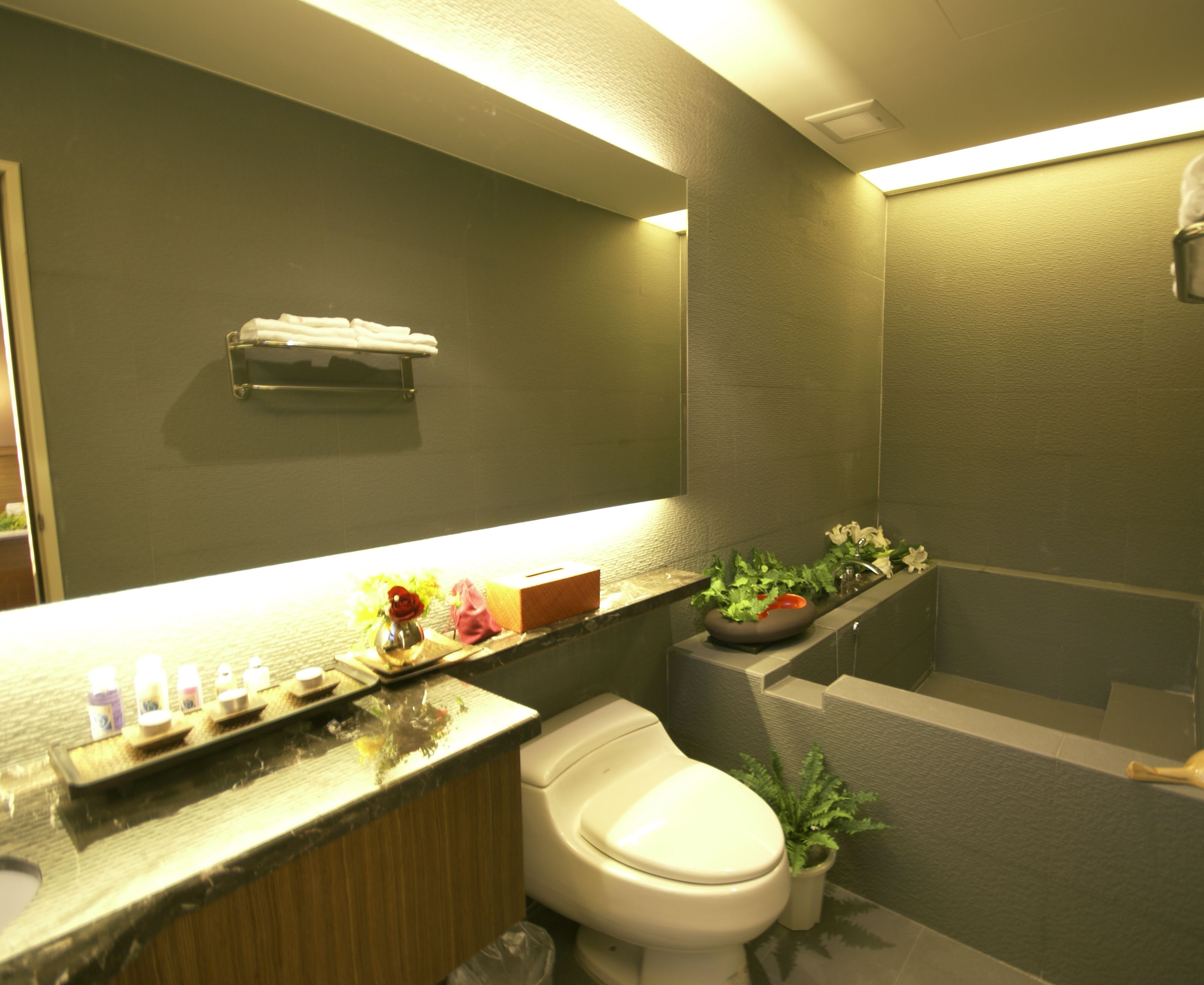A modern bathroom with a toilet, sink, and shower area.