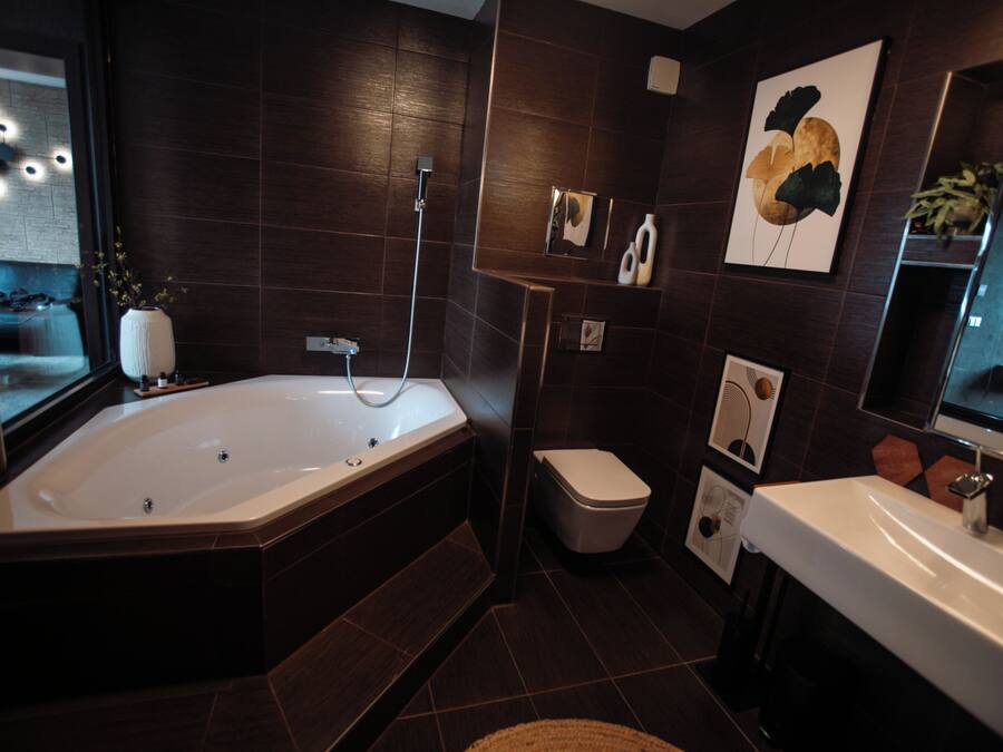 Ein modernes Badezimmer mit freistehender Badewanne, Toilette und Waschbecken.