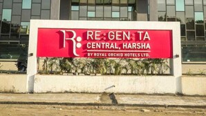 A hotel building with a sign reading "RE:GEN:TA CENTRAL, HARSHA BY ROYAL ORCHID HOTELS LTD." - Regenta Central Harsha Vapi (Pardi)