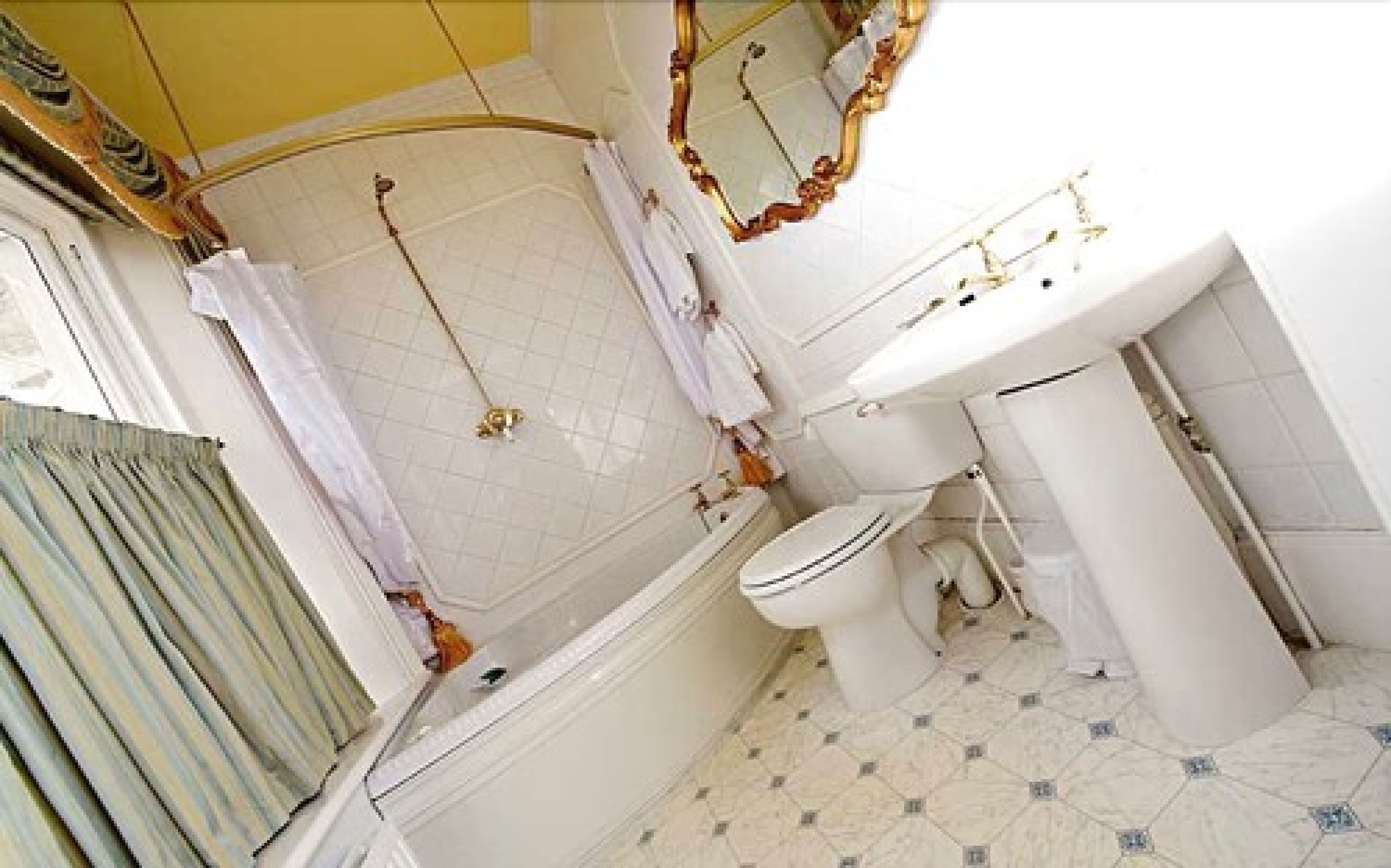 A bathroom with a bathtub, toilet, and sink.