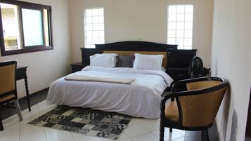 Desk, iron/ironing board, bed sheets