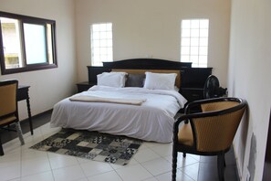 Desk, iron/ironing board, bed sheets