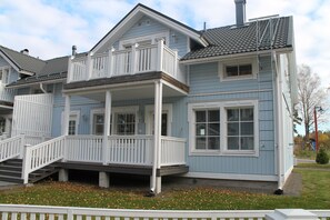 A two-story house with a balcony, a front porch, and a garage. - SResort Big Houses (Lappeenranta)