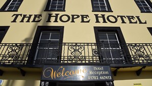 The exterior of The Hope Hotel with a 'Welcome' sign and a reception number. - The Hope Hotel (Southend-on-Sea)