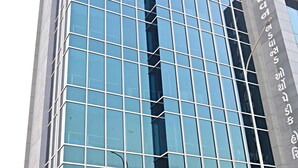 Un edificio moderno con fachada de vidrio y el nombre "ROYAL RITUALS" visible en grande.