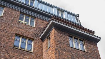 A multi-story brick building with large windows and a flat roof.