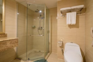 A modern bathroom with a glass-enclosed shower, a toilet, and a marble countertop. - Wanjia Dongfang Hotel (Shishi)