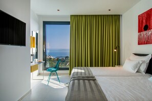 A modern bedroom with a large bed, a view of the city, and a balcony. - Villa Zvizdan (Makarska)