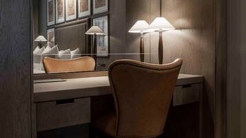 A modern bathroom with a vanity, a mirror, and two wall-mounted lamps.