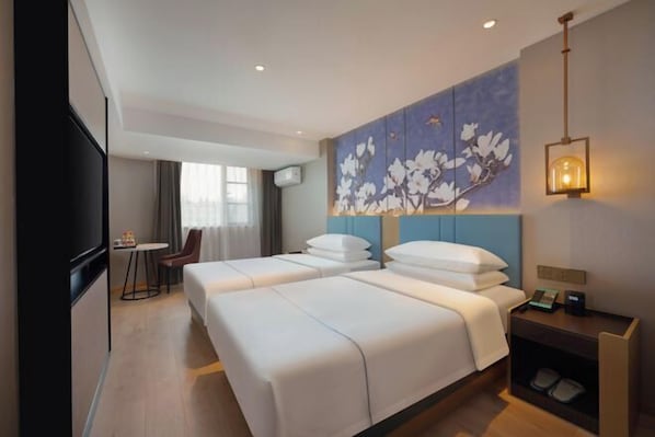 A hotel room with two beds, a desk, a chair, a wall-mounted TV, and a painting. - Magnotel Hotel (Nanjing Hongshan Zoo Maigaoqiao Subway Station) (Nanjing)