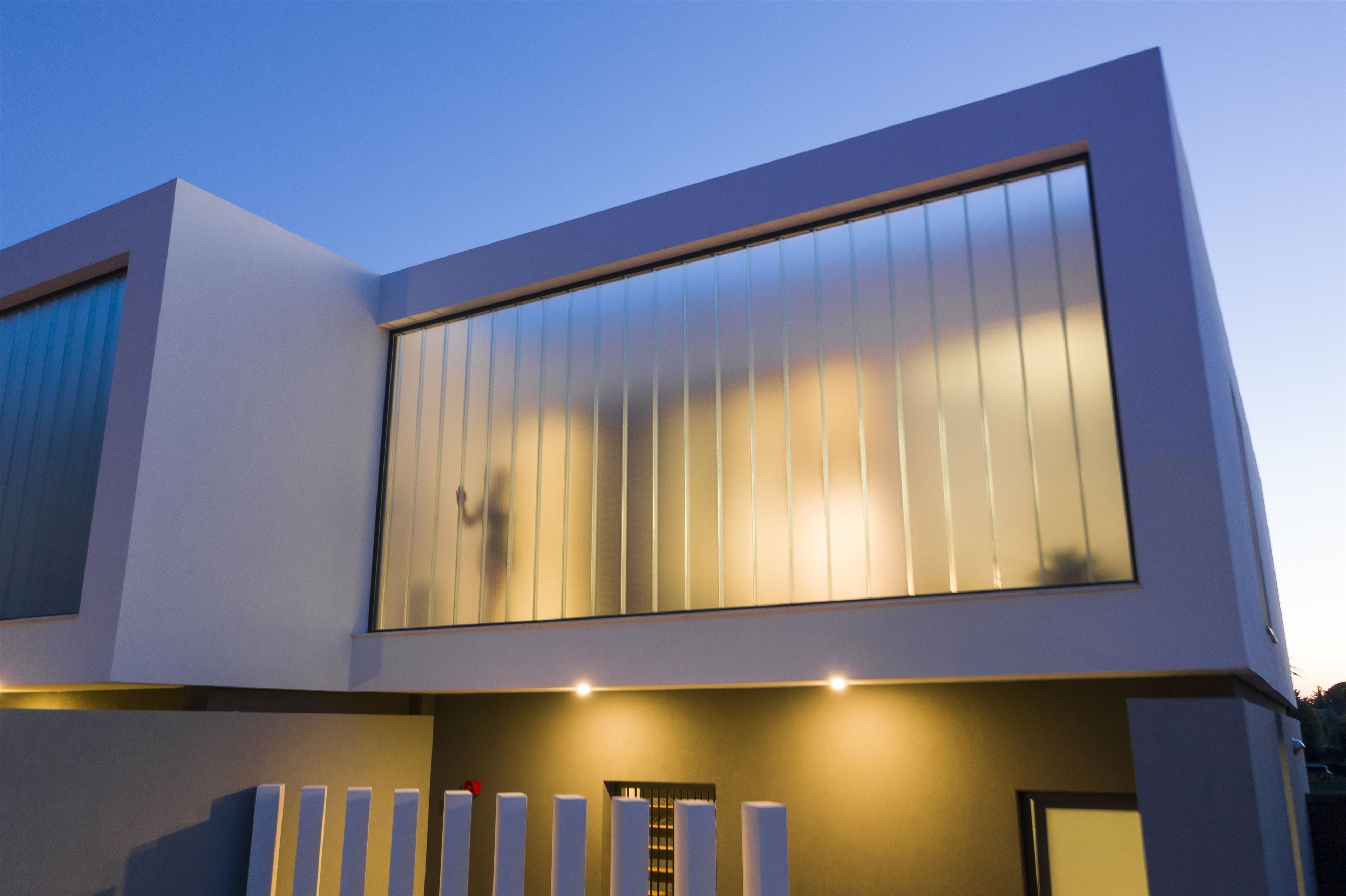 A modern building with large windows and a flat roof.