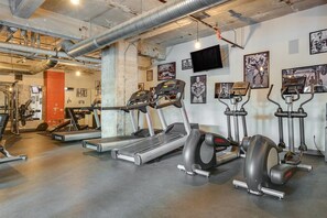 A gym with treadmills, elliptical machines, and weight equipment.
