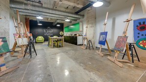 An art studio with easels, a table, and chairs. - Brand New Stunning Unit Downtown (Dallas)