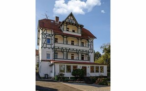 A multi-story building with a traditional architectural style, featuring a prominent balcony on the second floor. - HotelPension Erika (Bad Sooden-Allendorf)