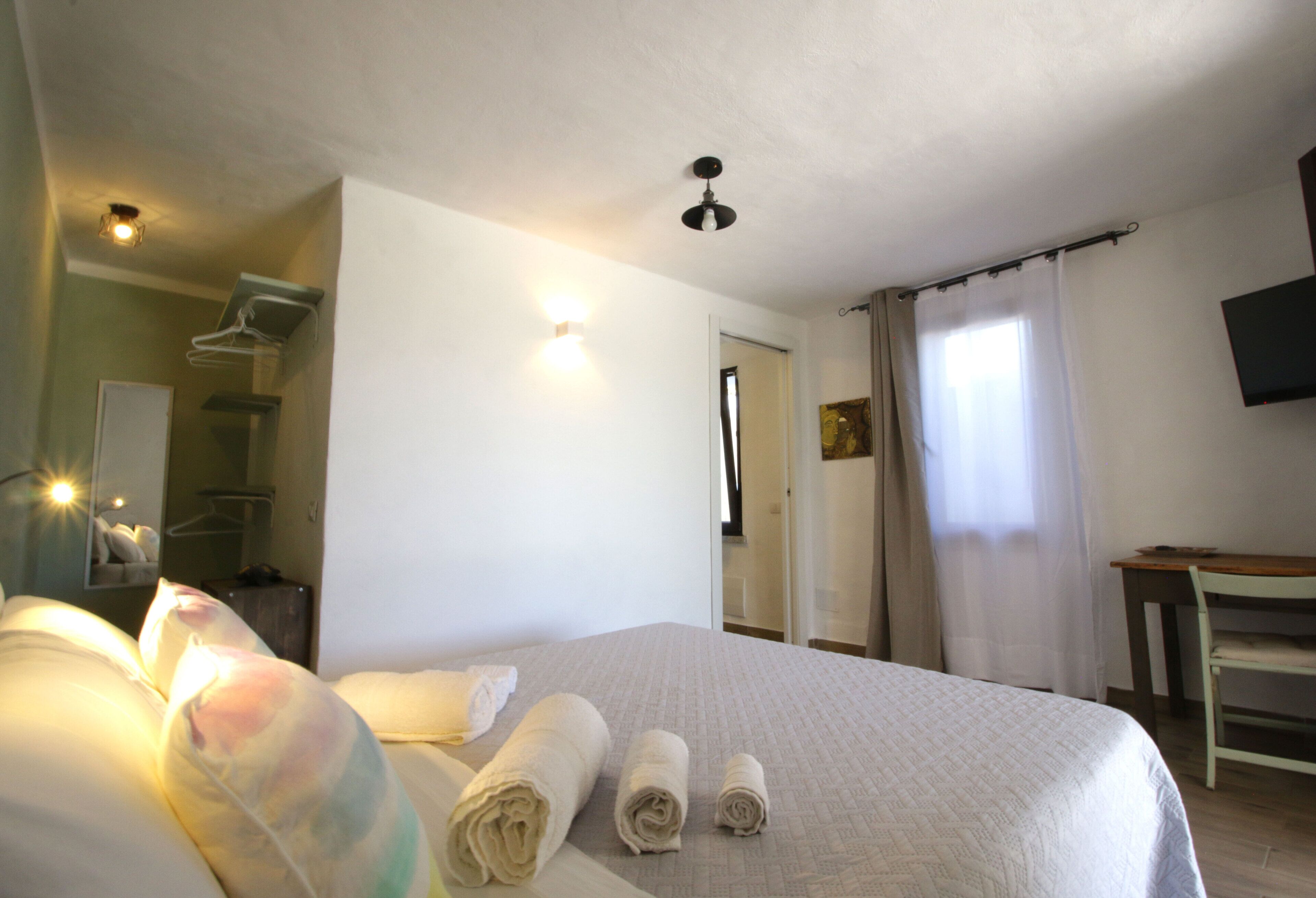 Comfort Room | Premium bedding, desk, laptop workspace, blackout curtains