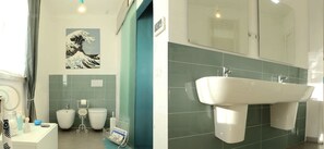 A bathroom with a large sink, two toilets, and a towel rack. - B&B Anacleto (Luogosanto)