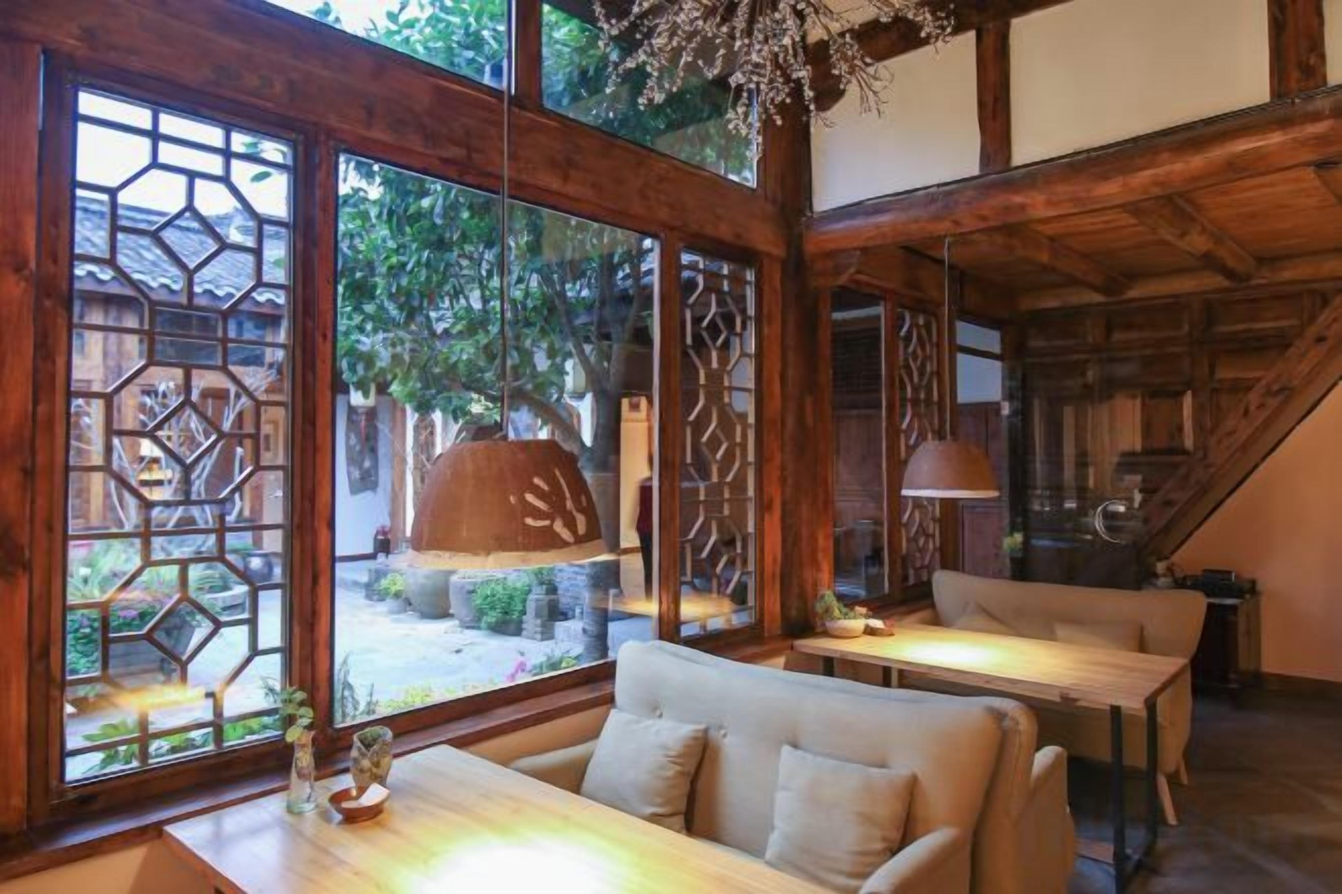 A traditional Japanese-style room with tatami flooring, a low table, and a sofa.