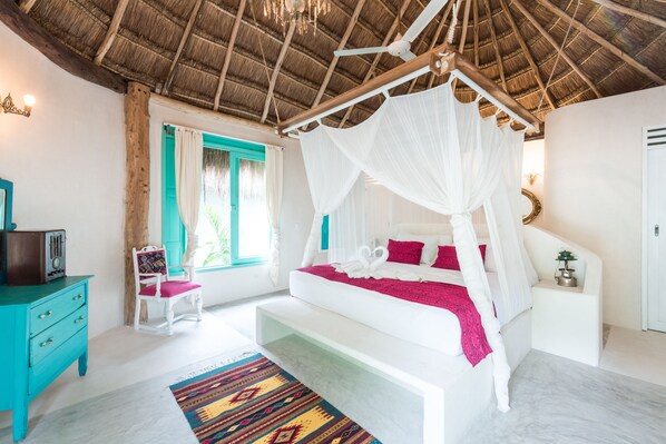 A bedroom with a bed under a canopy, a wooden dresser, a chair, and a window with curtains. - Cormoran Boutique Hotel & Cenote Tulum (Tulum)