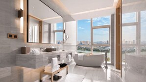 A modern bathroom with a large bathtub, a vanity with two sinks, a large mirror, and a view of a cityscape through large windows. - DoubleTree by Hilton Suzhou Wujiang (Suzhou)