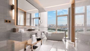 King One Bed Deluxe Suite | Bathroom | Shower, rainfall showerhead, towels