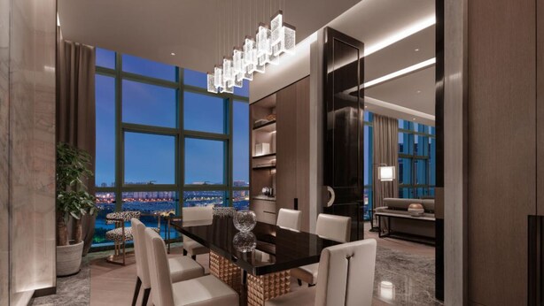 A modern dining area with a large table, chairs, and a city view through large windows. - DoubleTree by Hilton Suzhou Wujiang (Suzhou)