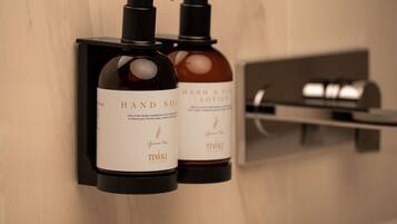 Two hand soap dispensers mounted on a wall, one labeled 'HAND SOAP' and the other 'HAND & BODY LOTION.'