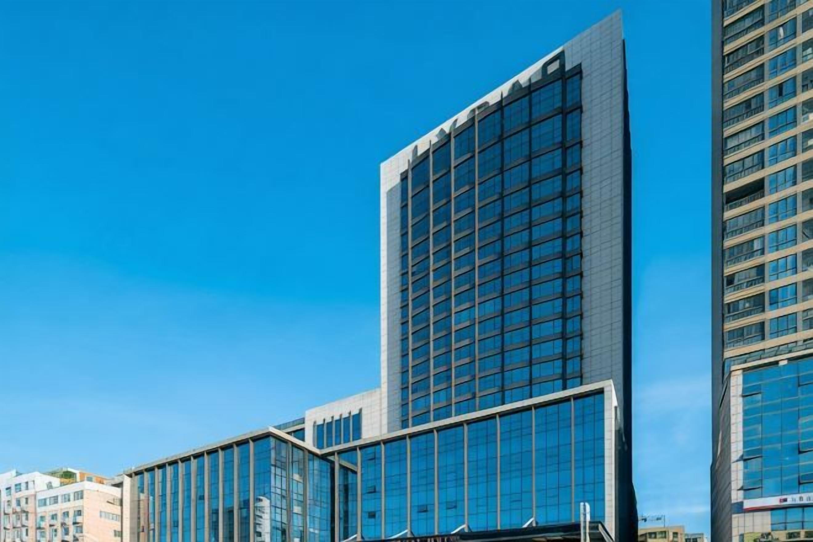 A high-rise building with a modern glass facade, likely a hotel or office building.