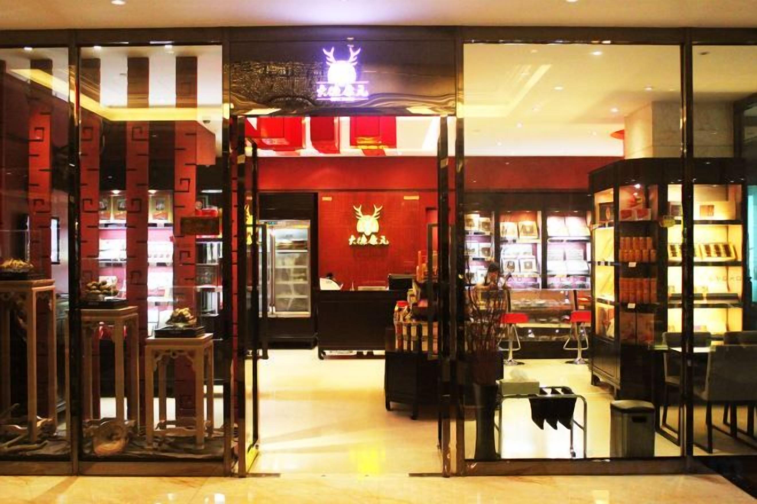 A bookstore with glass doors, shelves with books, and a red interior.