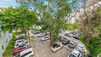 A parking lot with multiple cars and trees.