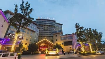 A multi-story hotel with a prominent entrance and a well-lit facade.