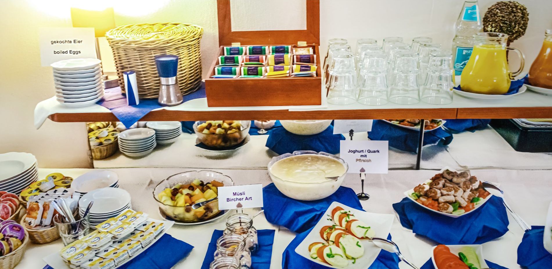 A buffet setup with various food items and beverages.