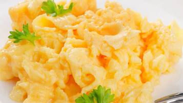 Scrambled eggs garnished with parsley.