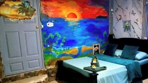 Une chambre à coucher avec un lit, une table de chevet et une fresque murale.