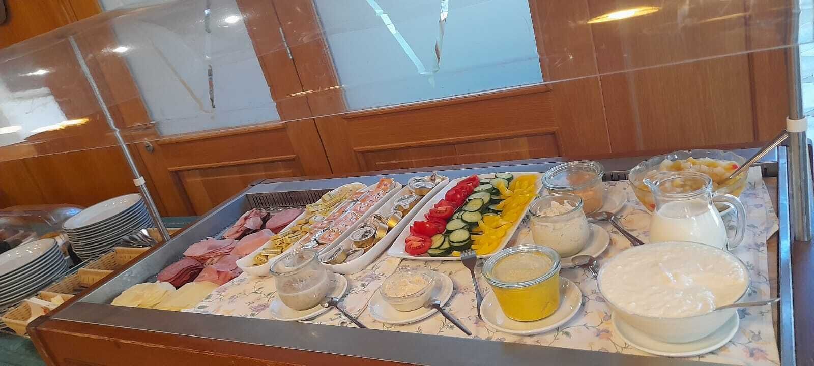 A buffet with various food items and condiments.